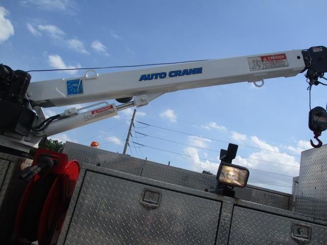An auto crane is attached to the back of a truck