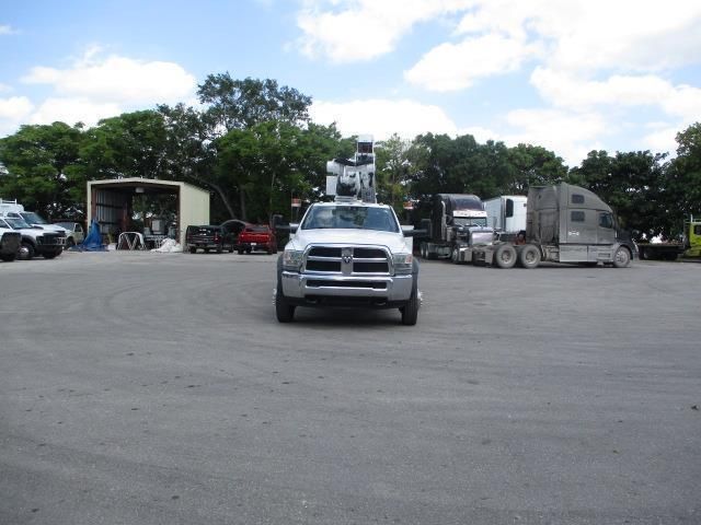A white dodge truck is parked in a parking lot