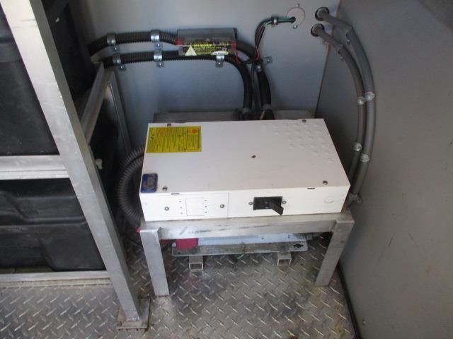 A white box is sitting on a metal shelf in a room