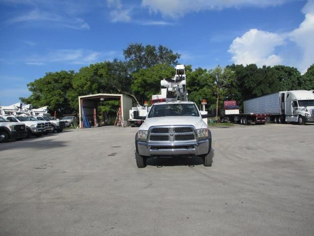 A white dodge truck is parked in a parking lot