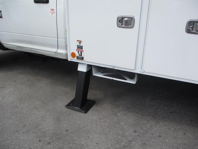 A white truck is parked on the side of the road