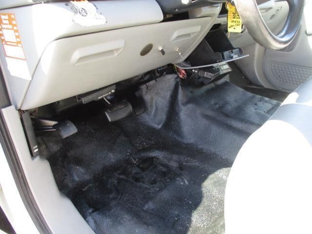 The inside of a car with a yellow tag on the steering wheel