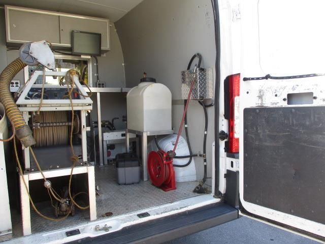 The back of a white van with a lot of equipment in it