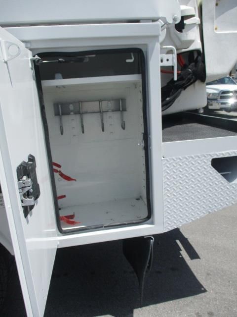 A white utility box with the door open on a truck