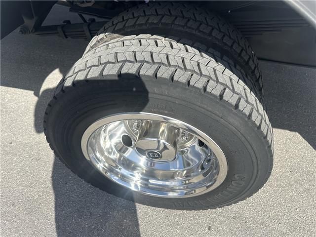 A close up of a tire with a chrome rim