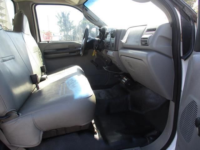 The interior of a white truck with the door open