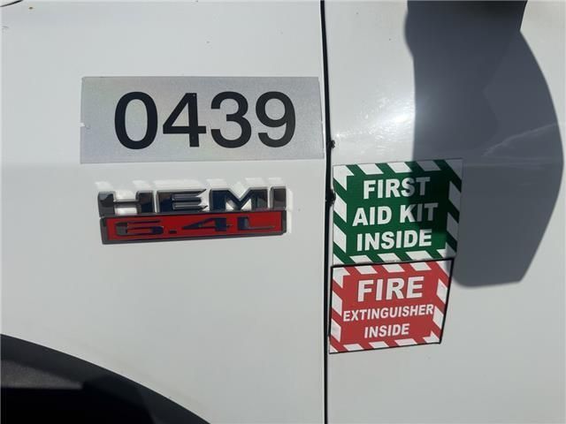 A white truck with a first aid kit inside sticker
