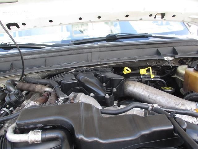 A close up of a car engine with the hood up