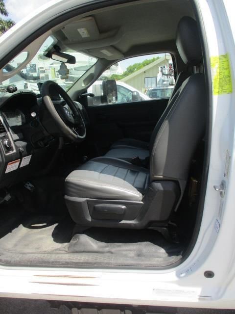 The inside of a white truck with the door open