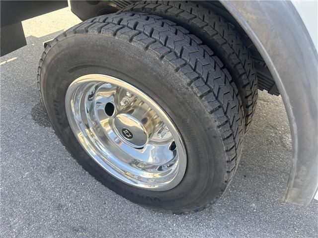 A close up of a tire on a truck with chrome wheels.