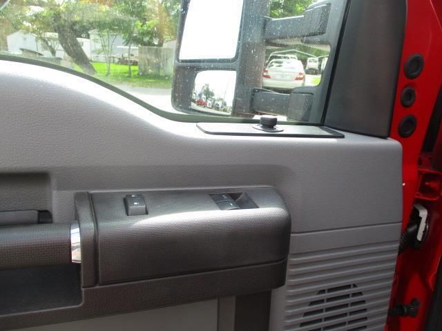 The inside of a red truck with the door open