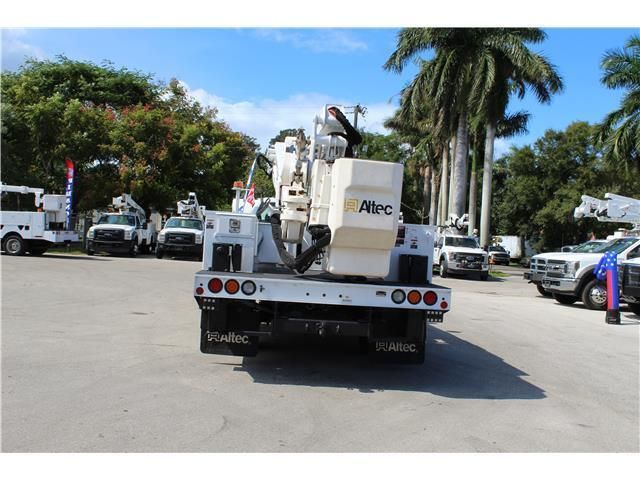A white truck with the word abc on the back is parked in a parking lot