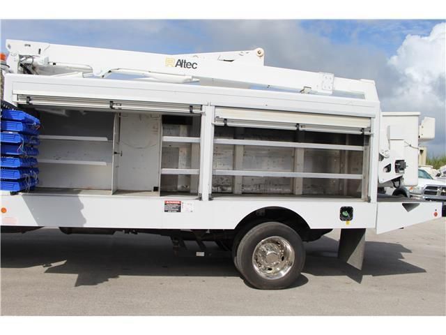 A white truck with a crane on top of it