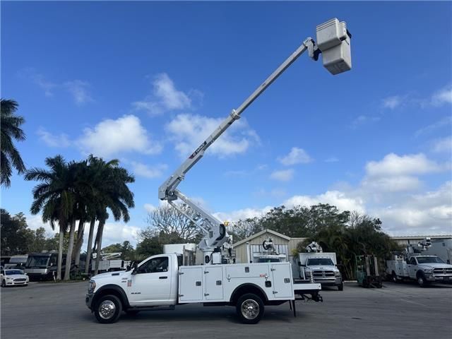 A white utility truck with a bucket on top of it