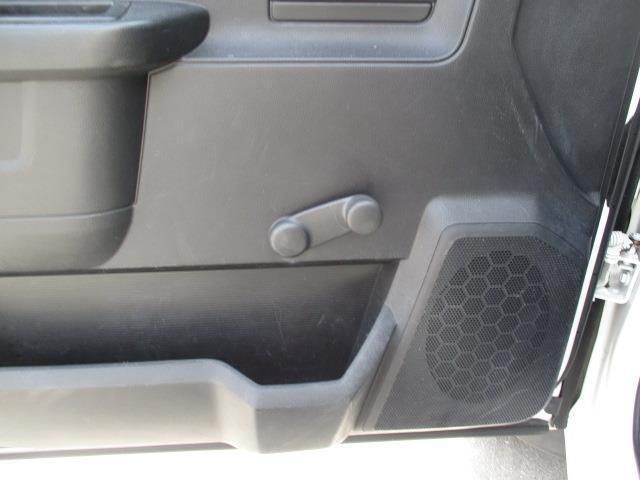 A close up of a car door with a speaker in it