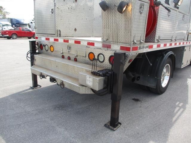 A silver truck is parked in a parking lot