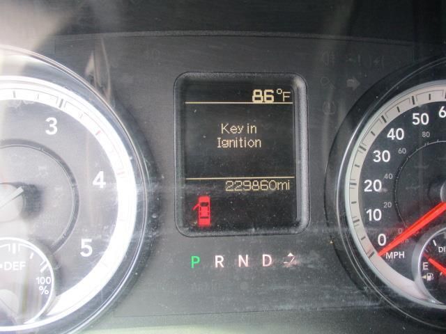 A close up of a car dashboard with a key in ignition displayed