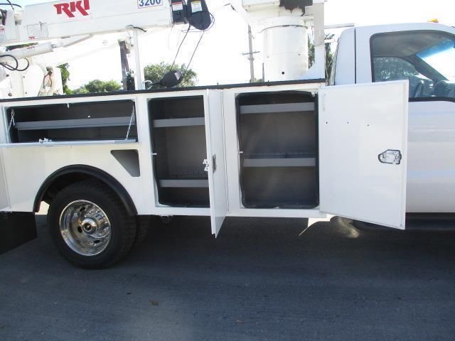 A white utility truck with the doors open