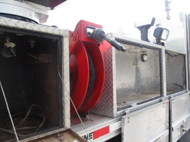 A red hose is attached to the side of a truck