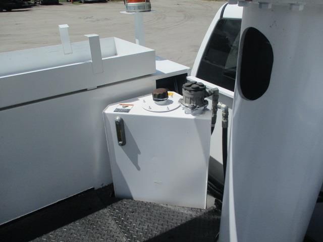 A white truck with a fuel tank in the back