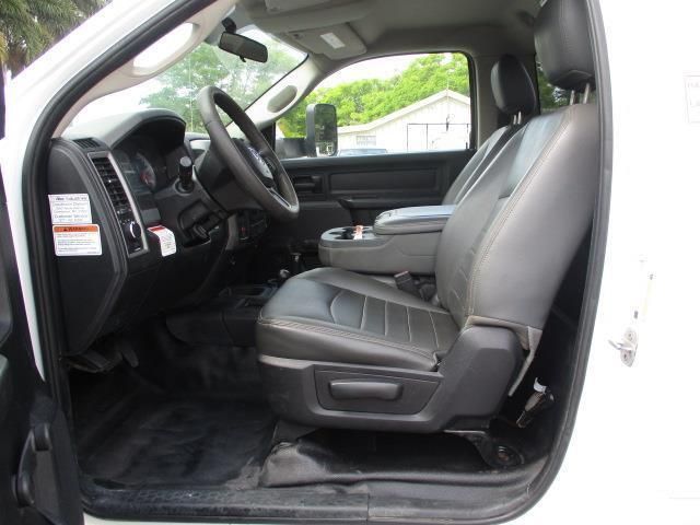 A white truck with black seats and a steering wheel