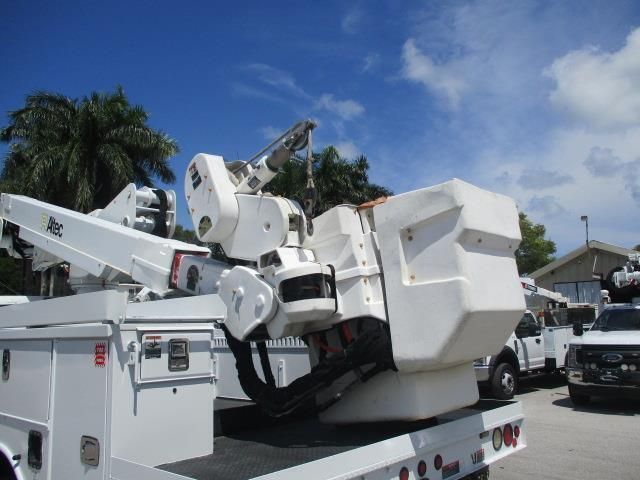 A white truck with a crane on the back of it