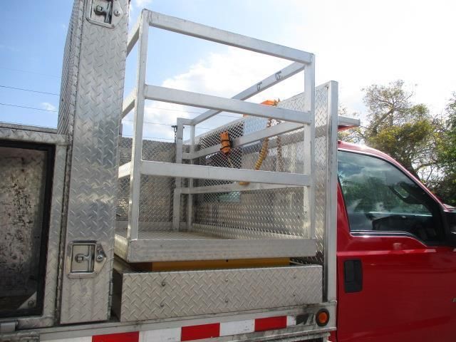 A red truck with a ladder on the back of it