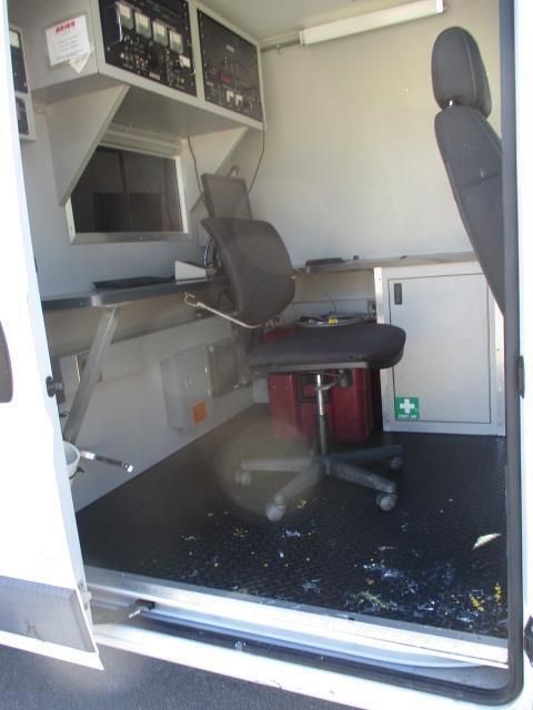 The inside of a van with a first aid box on the floor