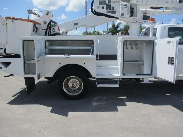 A white utility truck with the doors open