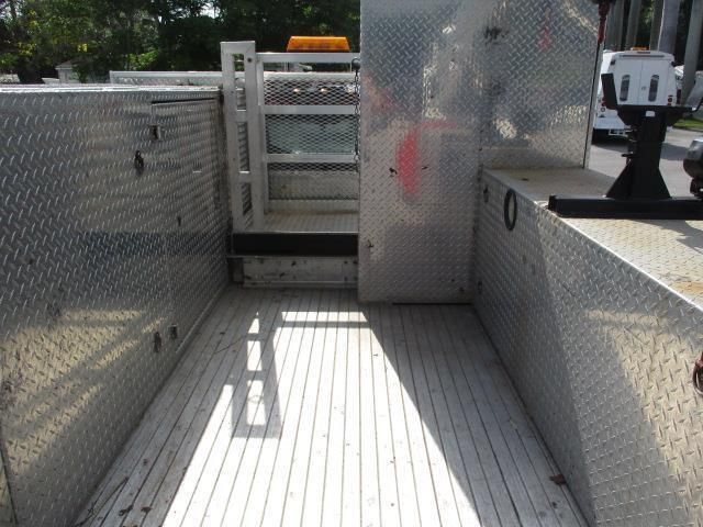 The inside of an aluminum truck with a wooden floor