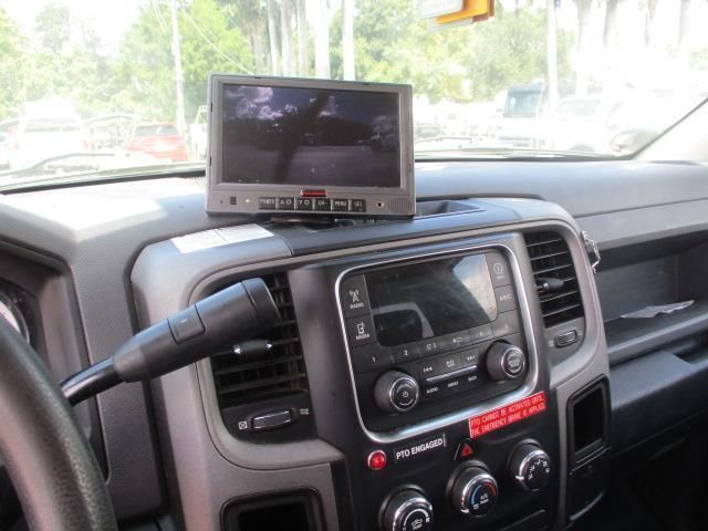 A car dashboard with a rear view camera and a radio