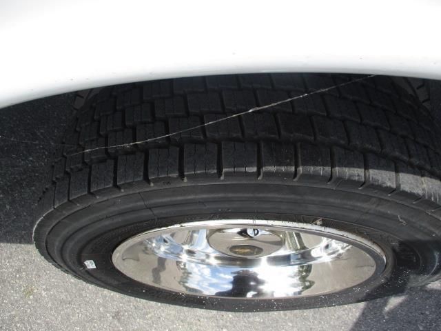 A close up of a car tire with chrome rims
