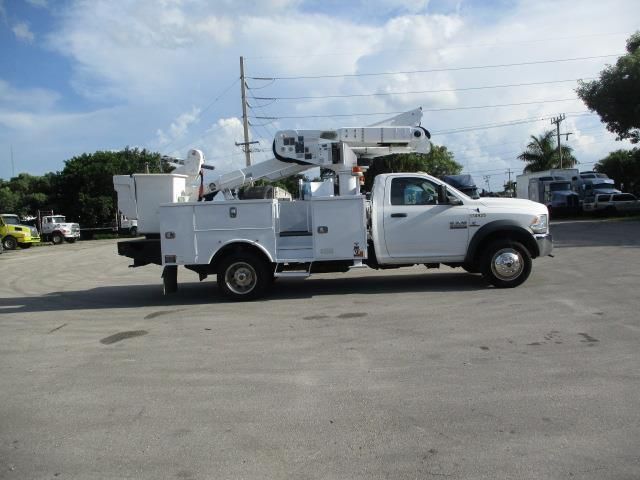 A white utility truck is parked in a parking lot