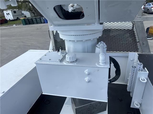 A white machine with a black hose attached to it