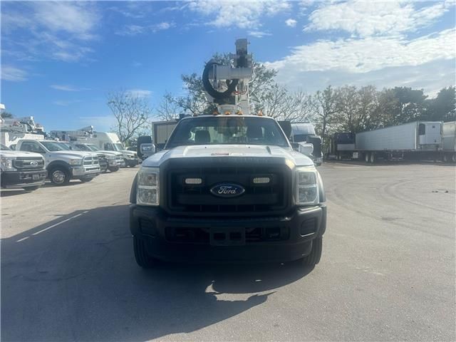 A white ford truck is parked in a parking lot