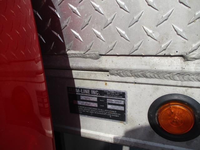 A red truck with a license plate that says v-line inc