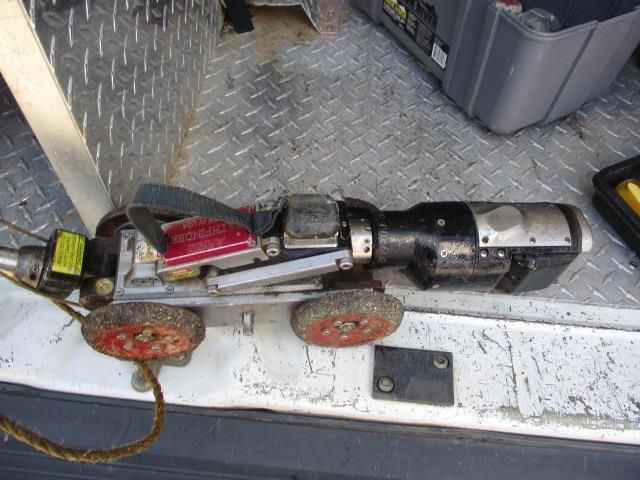 A machine is sitting on the back of a van.