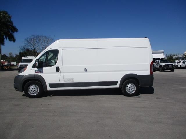 A white van is parked in a parking lot.