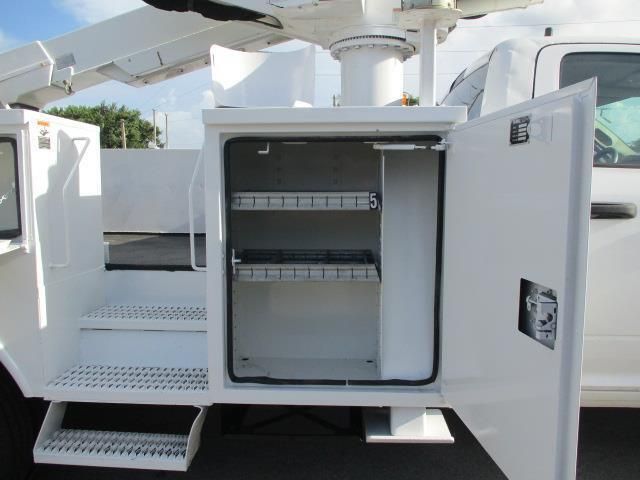 A white utility truck with the door open