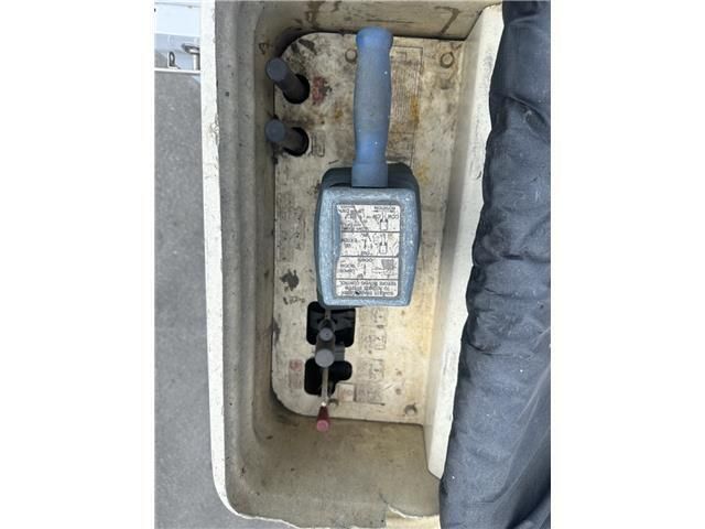 A close up of a remote control on the side of a vehicle.