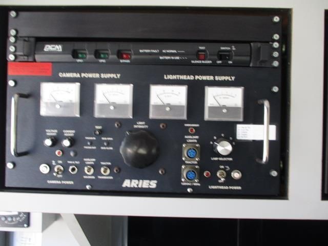 A black aries control panel with many buttons and gauges