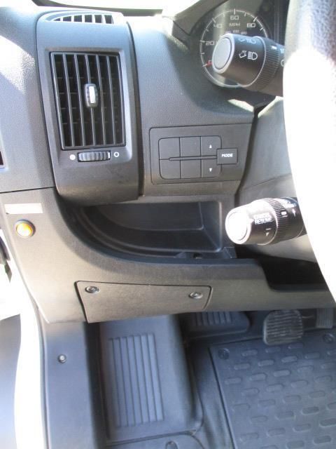 A close up of a car dashboard with a steering wheel