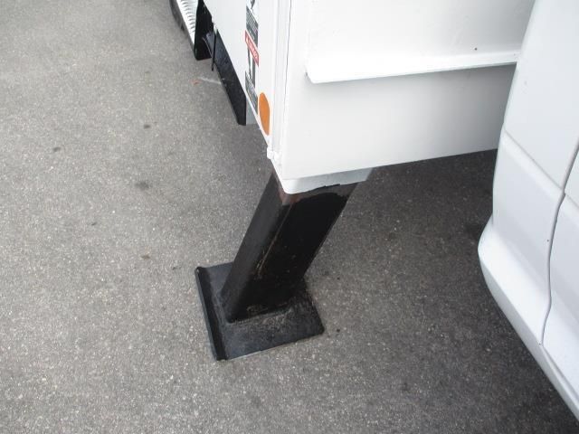 A white truck is parked on the side of the road