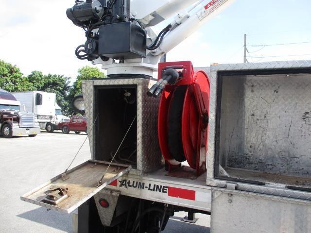 A slum-line truck is parked in a parking lot