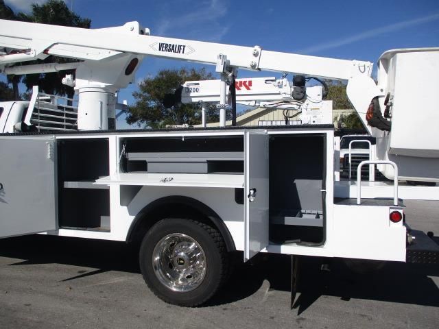 A white utility truck with a crane on top of it
