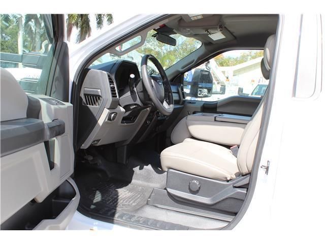 The interior of a white truck with the door open