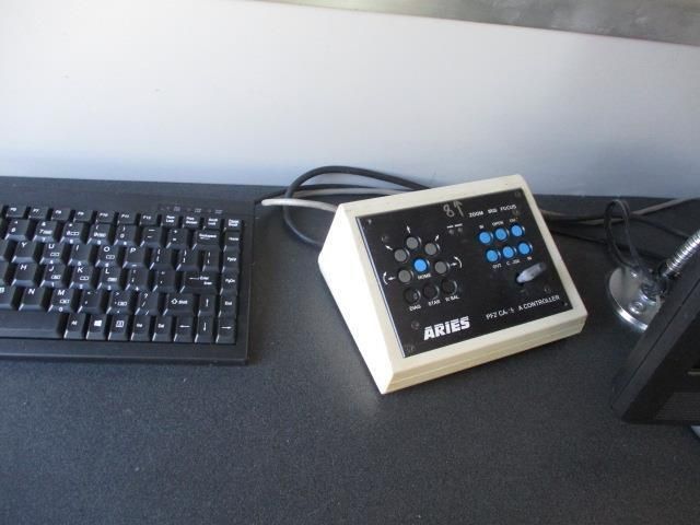 A white box that says aries sits next to a black keyboard