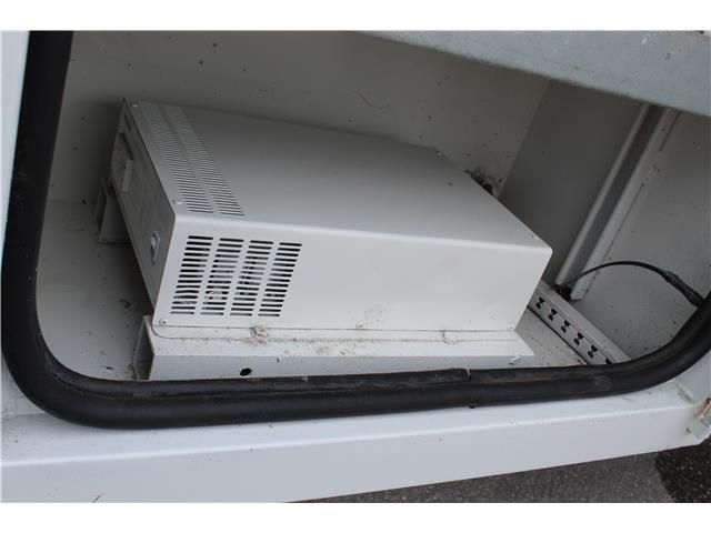 A white box is sitting in the trunk of a vehicle