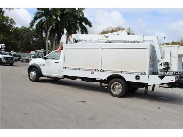 A white utility truck is parked in a parking lot