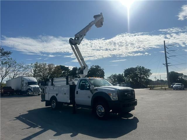 A white truck with a crane on top of it